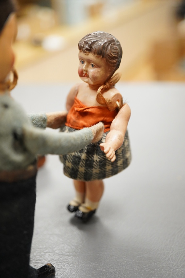 A Gescha, DRGM (Germany), clockwork tinplate acrobatic bellboy on ‘Express’ trunk, together with a Schuco, Germany tinplate and cellulose clockwork man with girl automaton